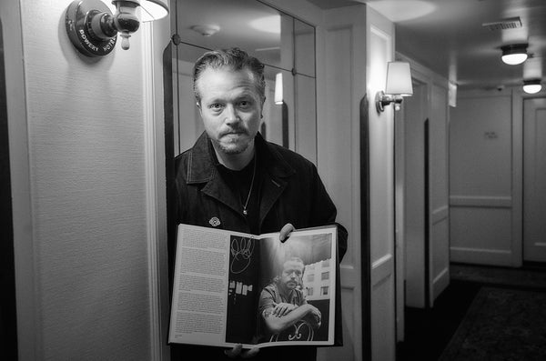Jason Isbell with his copy of New York is Dead? Long Live New York! by Leo Jacob