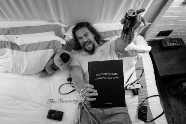 Jason Momoa with his copy of New York is Dead? Long Live New York! by Leo Jacob