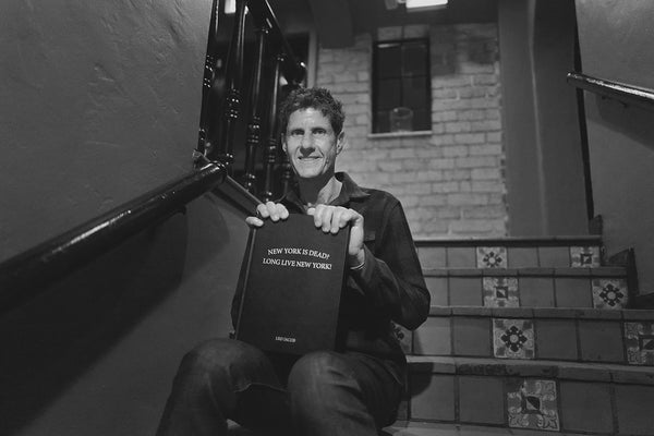 Mike D with his copy of New York is Dead? Long Live New York! by Leo Jacob